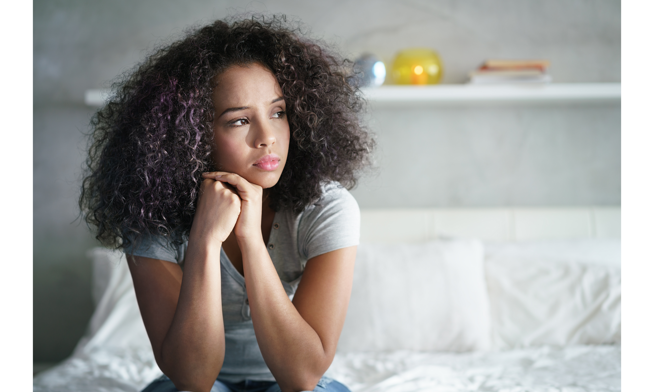 Image of Woman with Anxiety Sitting on Bed